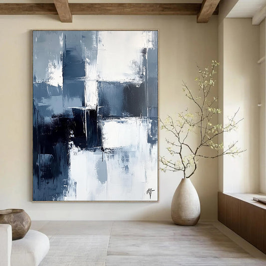 Large contemporary abstract painting featuring dark blue and white brushstrokes on a light gray background evoking calmness and simplicity. DLZ0351