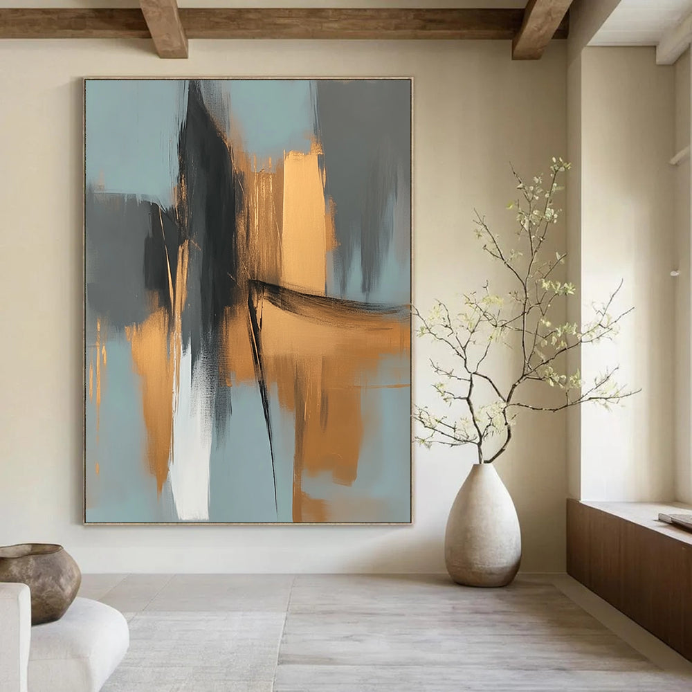 Large contemporary abstract painting features elegant gold and gray shapes against a light blue background evoking an urban landscape with serene organic forms. DLZ0706