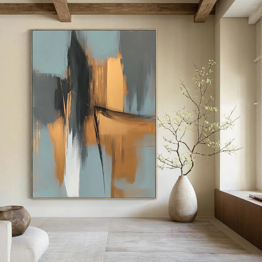 Large contemporary abstract painting features elegant gold and gray shapes against a light blue background evoking an urban landscape with serene organic forms. DLZ0706