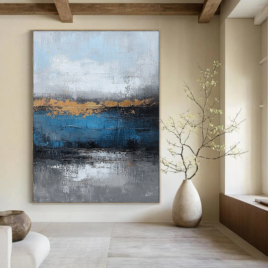 Contemporary large hand-painted abstract artwork featuring blue and gray textures with gold leaf accents on canvas for a striking wall display. DLZ0346