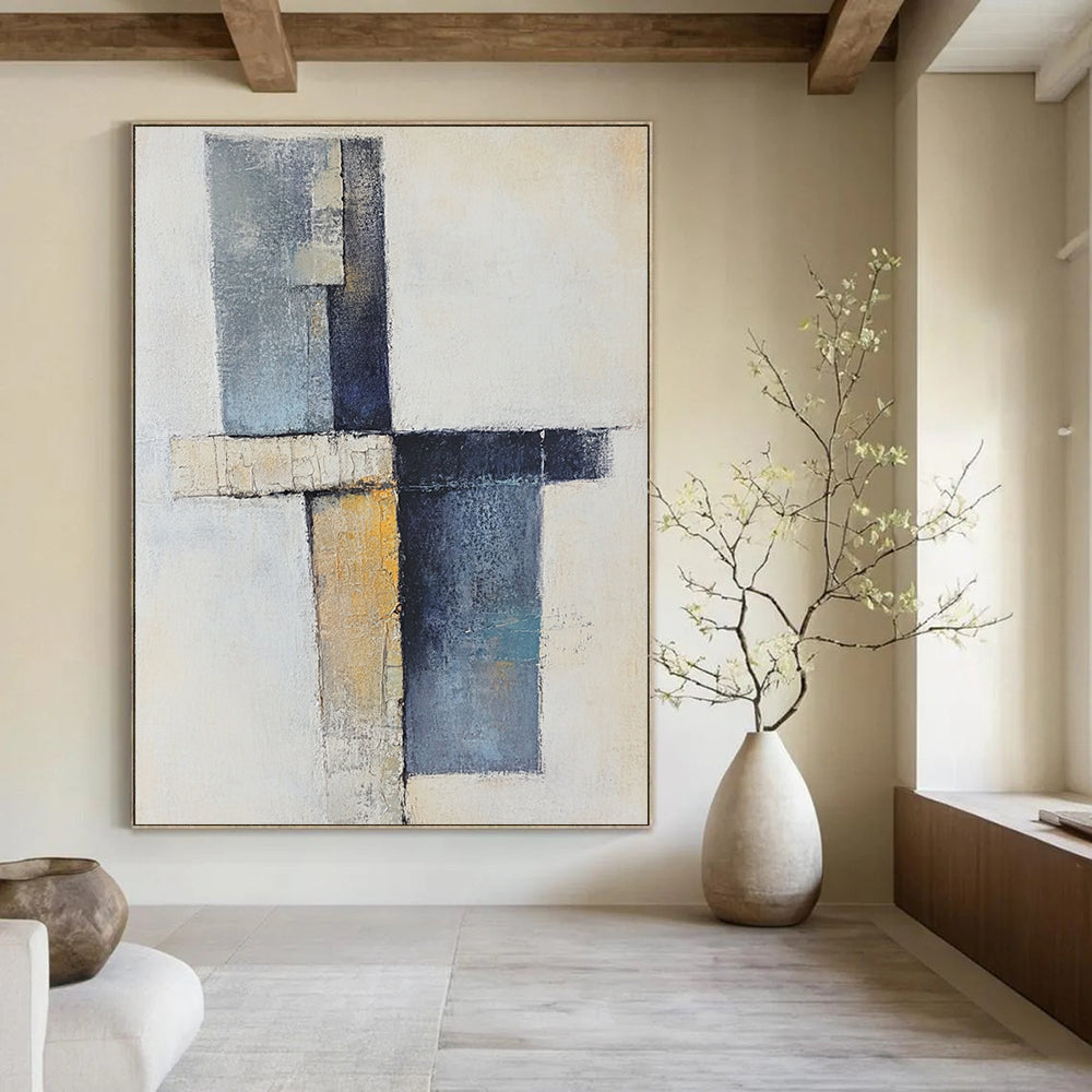 Contemporary abstract artwork showcasing a cross with soft shapes in earthy tones and blue-gray, featuring a vertical line and scattered blocks. DLZ0969