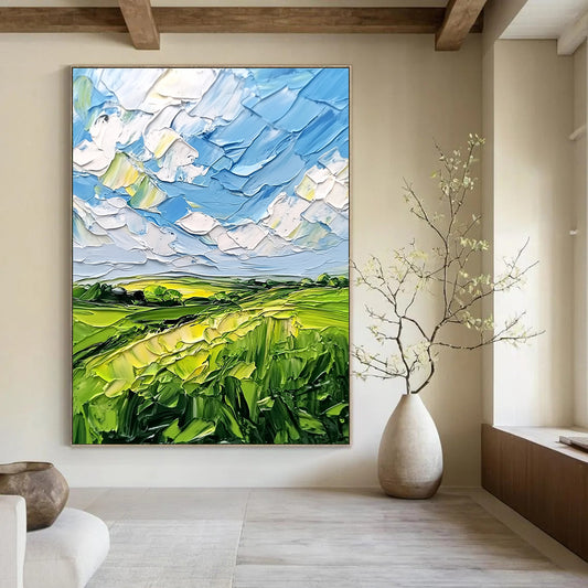 Contemporary abstract artwork featuring lush green fields and a vibrant blue sky with clouds, textured with bold impasto strokes. DLZ0484