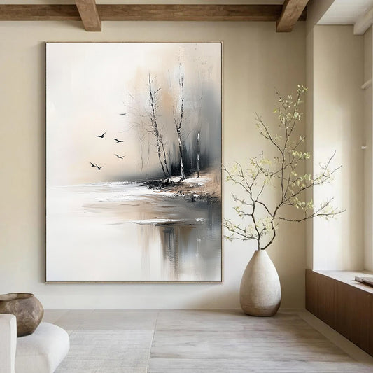 Large contemporary abstract painting featuring serene trees by an ice-covered lake with flying birds in soft gray and beige tones. DLZ0411