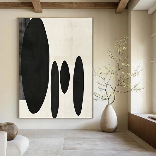 Contemporary minimalist artwork featuring organic black shapes balancing large forms on the left with delicate smaller shapes on the right. DLZ1547