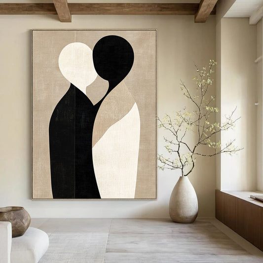 Large contemporary abstract art featuring minimalist shapes in black and beige, embracing forms on a textured light brown background. DLZ1464