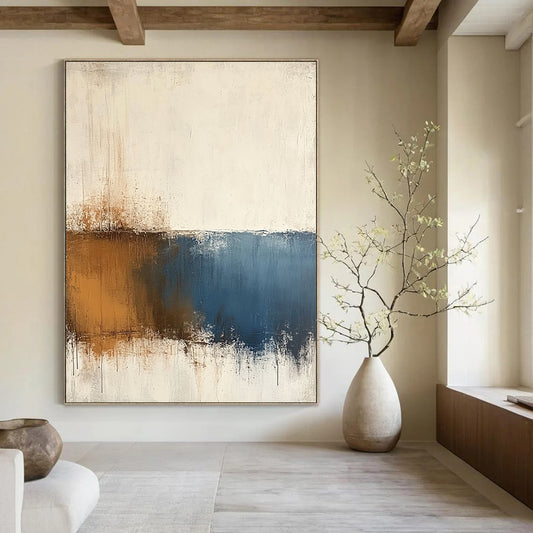 Contemporary hand-painted abstract art features beige and blue tones on a textured white background with minimalist soft edges and subtle brown accents. DLZ0725