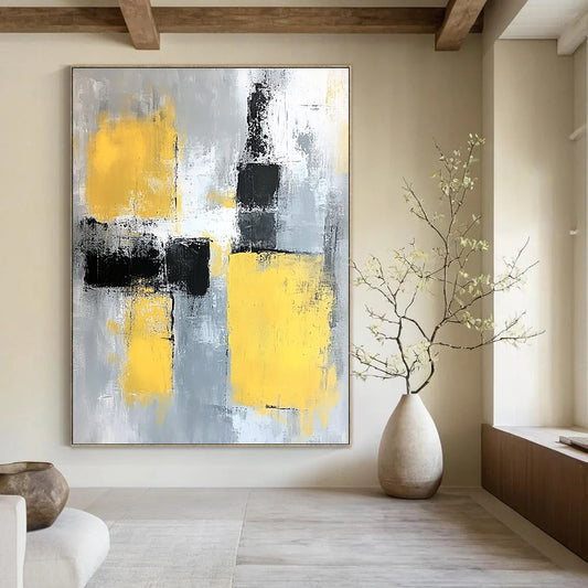 Contemporary abstract painting featuring gray and yellow color blocks with soft edges and dynamic brush strokes on a large canvas. DLZ0522