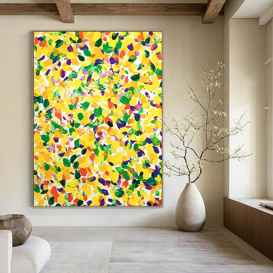 Vibrant contemporary abstract art featuring a large yellow canvas splashed with joyful green and purple spots against a clean white background. DLZ1297