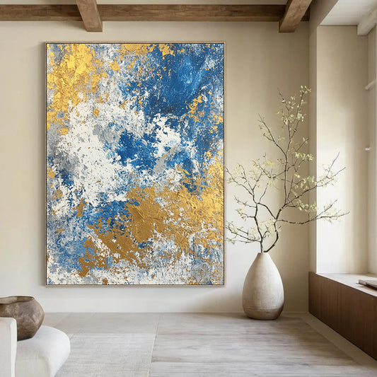 Large contemporary abstract painting featuring a textured blend of blue gold beige white and silver colors. Perfect for modern decor. DLZ0339