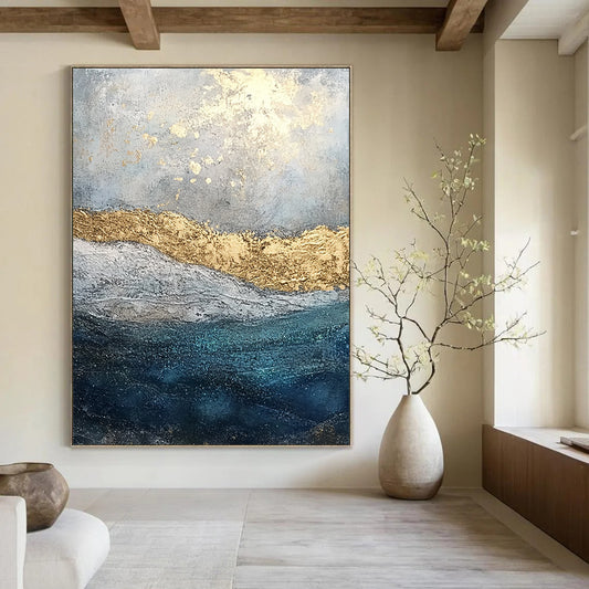 Contemporary abstract painting features textured layers of paint and glitter with a soft gray sky and deep blue sea enhanced by golden foil accents. DLZ1078