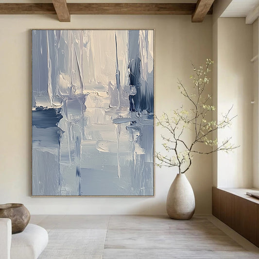 Large contemporary abstract painting featuring textured layers of blue and gray tones with soft lighting reflecting a serene coastal landscape. DLZ0352