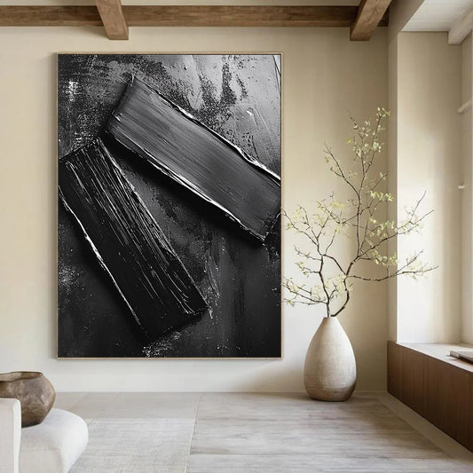Abstract contemporary artwork featuring smooth black oil-painted metal pieces arranged on the ground reflecting mechanical elements and minimalist design. DLZ1551