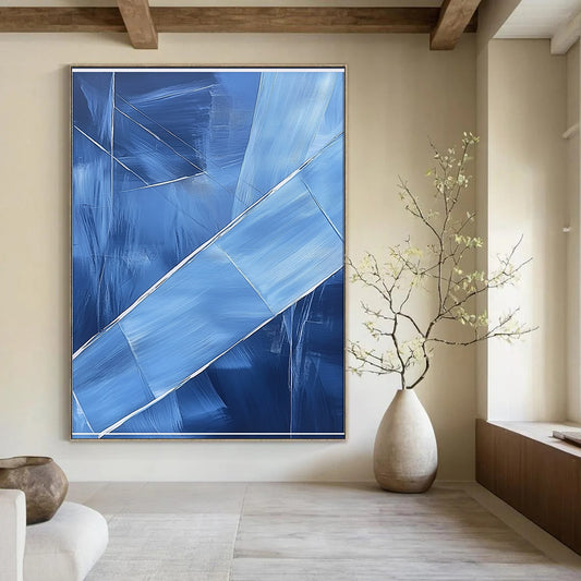 Contemporary hand-painted abstract art featuring blue shapes overlapping with soft edges and textured brushstrokes accented by a large white frame on the canvas. DLZ0367