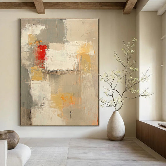 Contemporary abstract painting features neutral tones with red and yellow accents large brush strokes and textures in expansive white spaces. DLZ0921