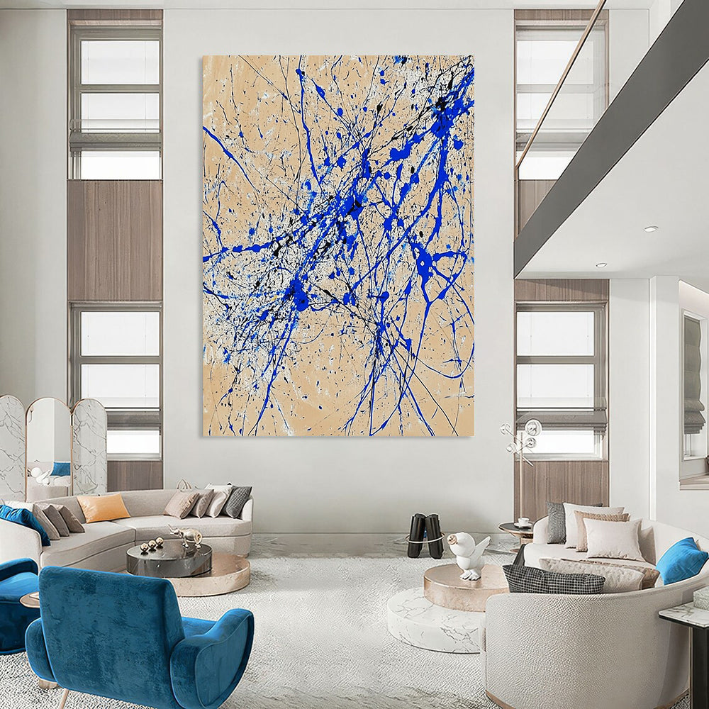 Contemporary abstract art features dynamic blue and white lines on beige paper in a vertical splatter style reminiscent of Jackson Pollock. DLZ0977