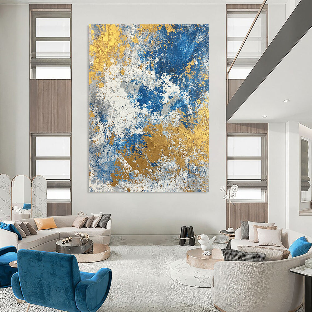 Large contemporary abstract painting featuring a textured blend of blue gold beige white and silver colors. Perfect for modern decor. DLZ0339
