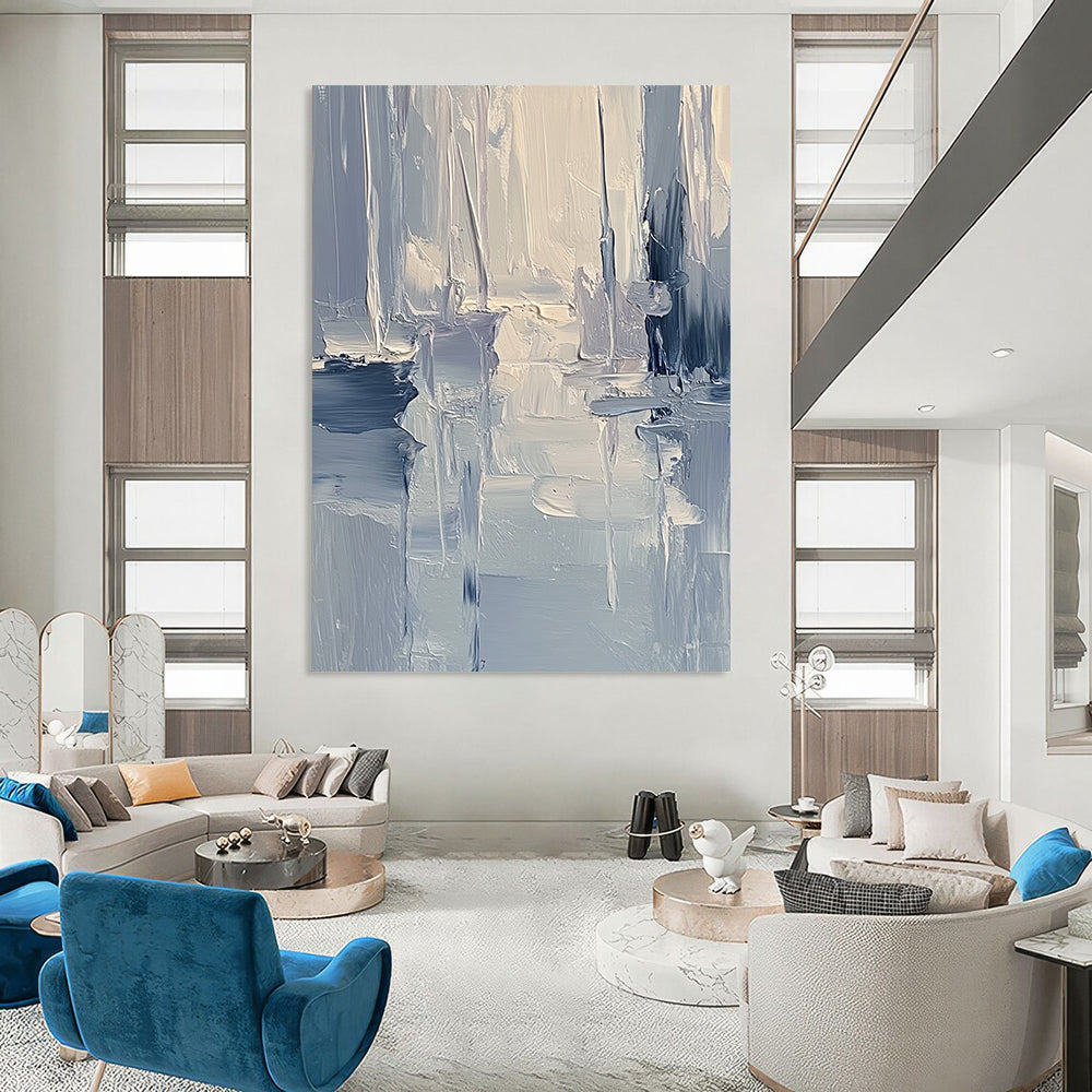 Large contemporary abstract painting featuring textured layers of blue and gray tones with soft lighting reflecting a serene coastal landscape. DLZ0352