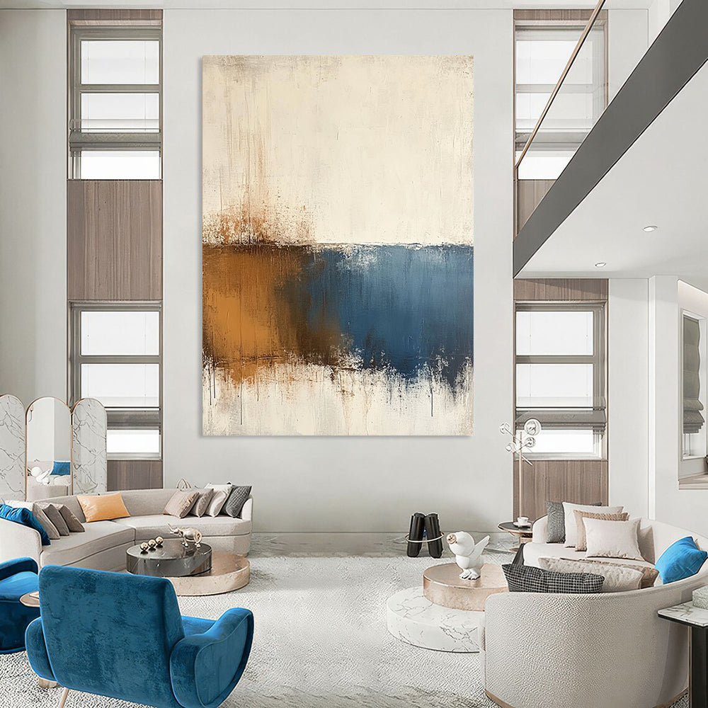 Contemporary hand-painted abstract art features beige and blue tones on a textured white background with minimalist soft edges and subtle brown accents. DLZ0725