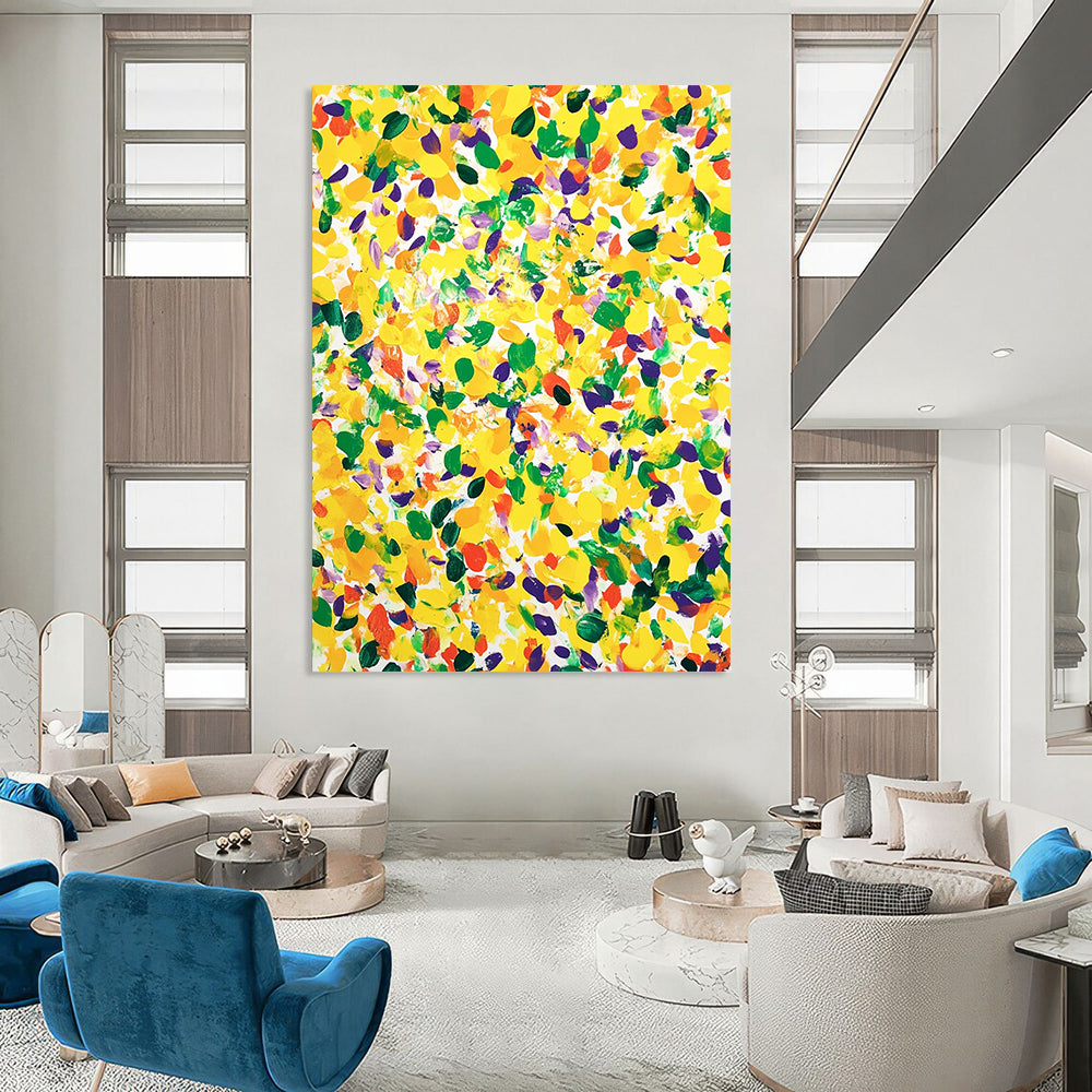 Vibrant contemporary abstract art featuring a large yellow canvas splashed with joyful green and purple spots against a clean white background. DLZ1297