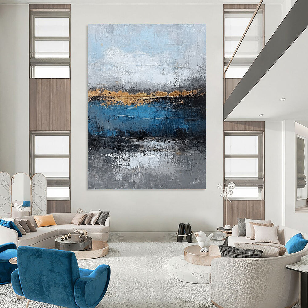 Contemporary large hand-painted abstract artwork featuring blue and gray textures with gold leaf accents on canvas for a striking wall display. DLZ0346