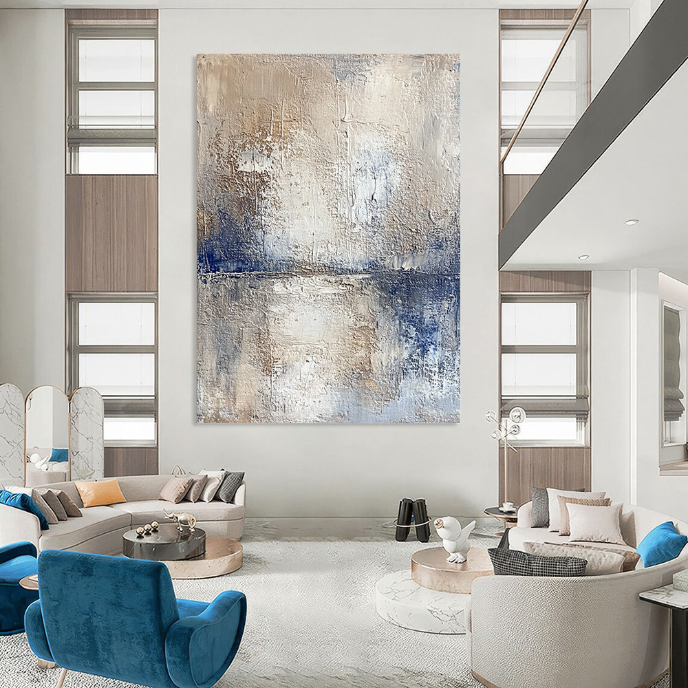 Contemporary hand-painted abstract artwork depicting a serene lake and sky with textured beige tones and vibrant blue accents for a striking visual experience. DLZ0471
