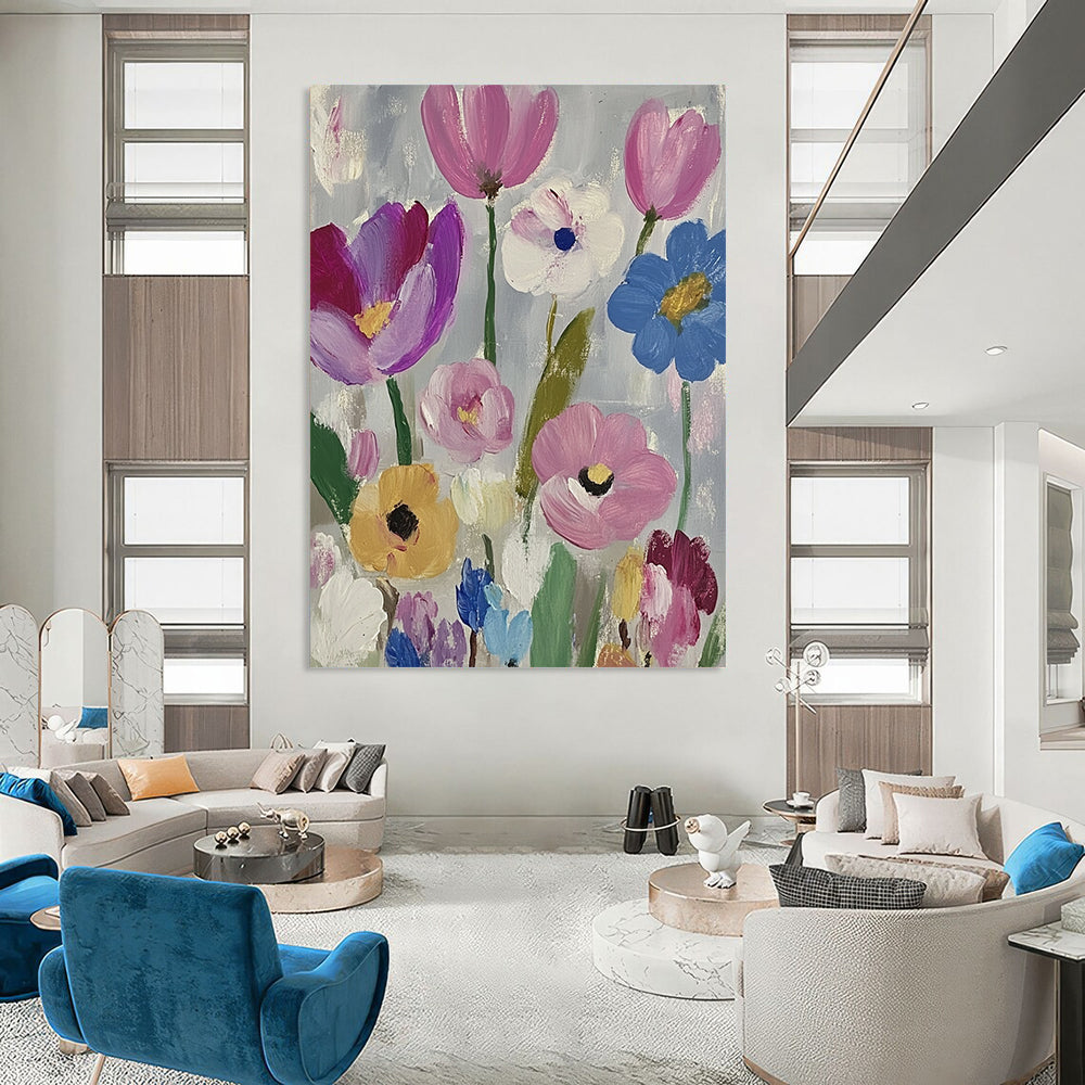 Large contemporary abstract painting featuring vibrant daisies and tulips in pink purple blue green and yellow against a soft gray backdrop with visible brush strokes. DLZ1262