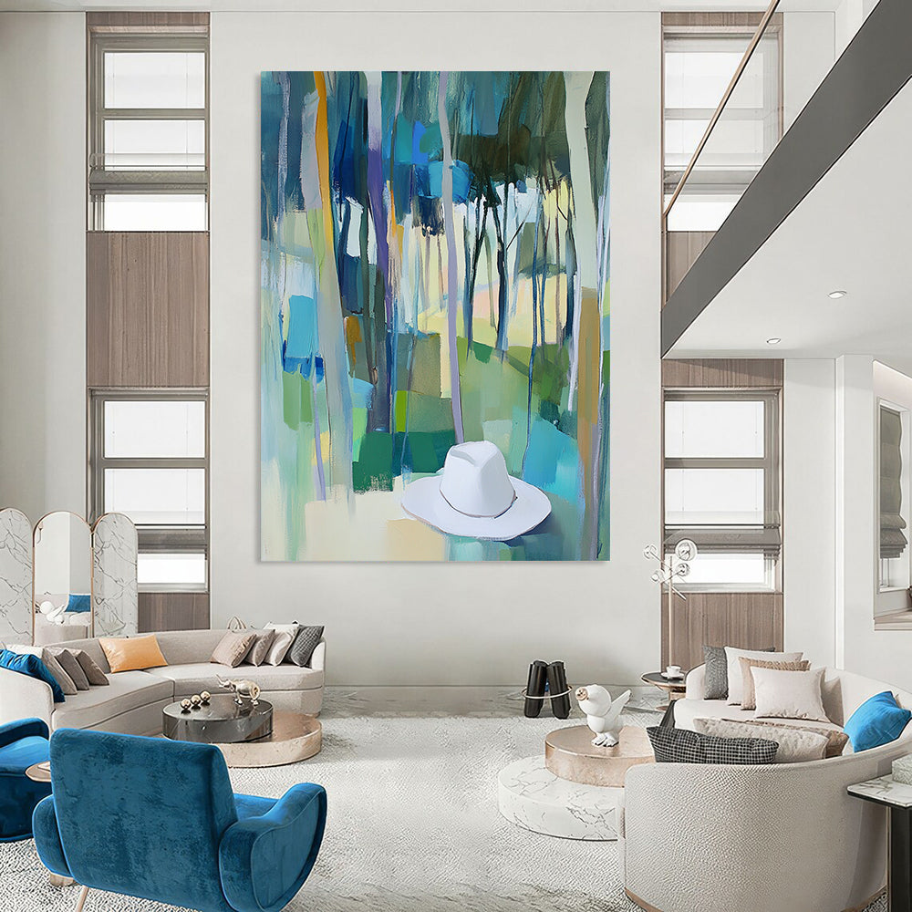 Contemporary abstract painting featuring trees in vibrant blue, green, and yellow hues with a white hat resting on the ground. DLZ0897