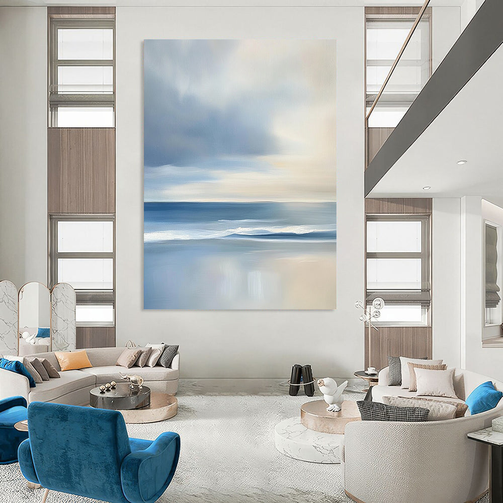 Contemporary abstract artwork features a serene ocean with gentle waves and soft clouds, showcasing light blues and grey tones for a tranquil ambiance. DLZ1460