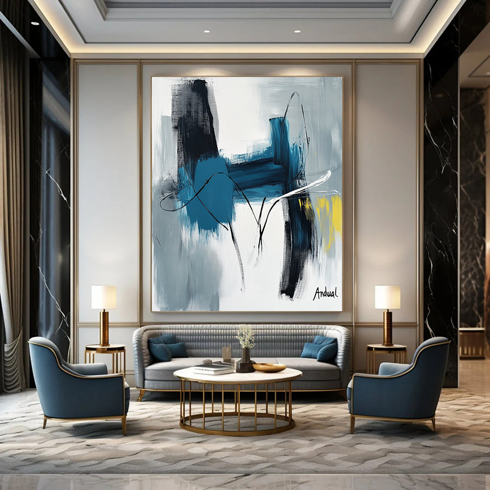 Contemporary abstract art showcasing "Andual" with bold strokes in blue and white on neutral canvas featuring black lines and hints of yellow or gray. DLZ0866
