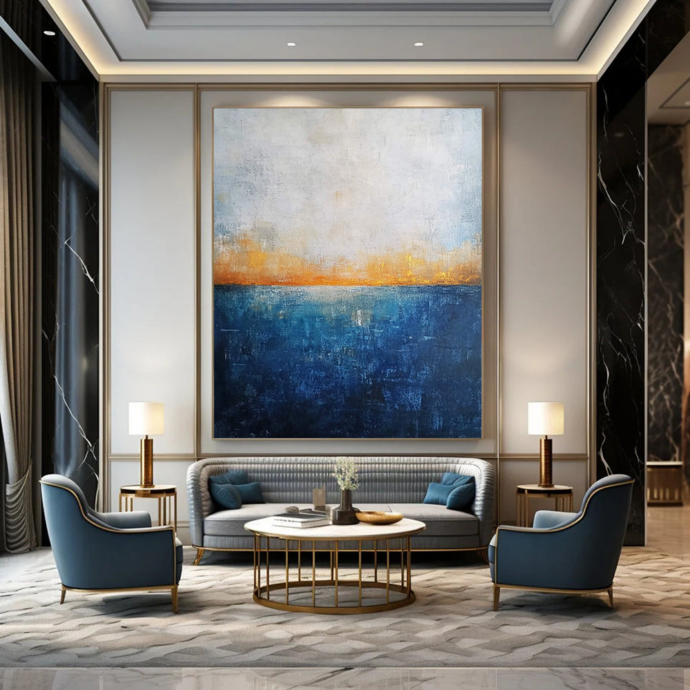 Contemporary abstract artwork featuring a deep blue ocean textured canvas with misty horizon neutral colors and elegant gold highlights. DLZ0468
