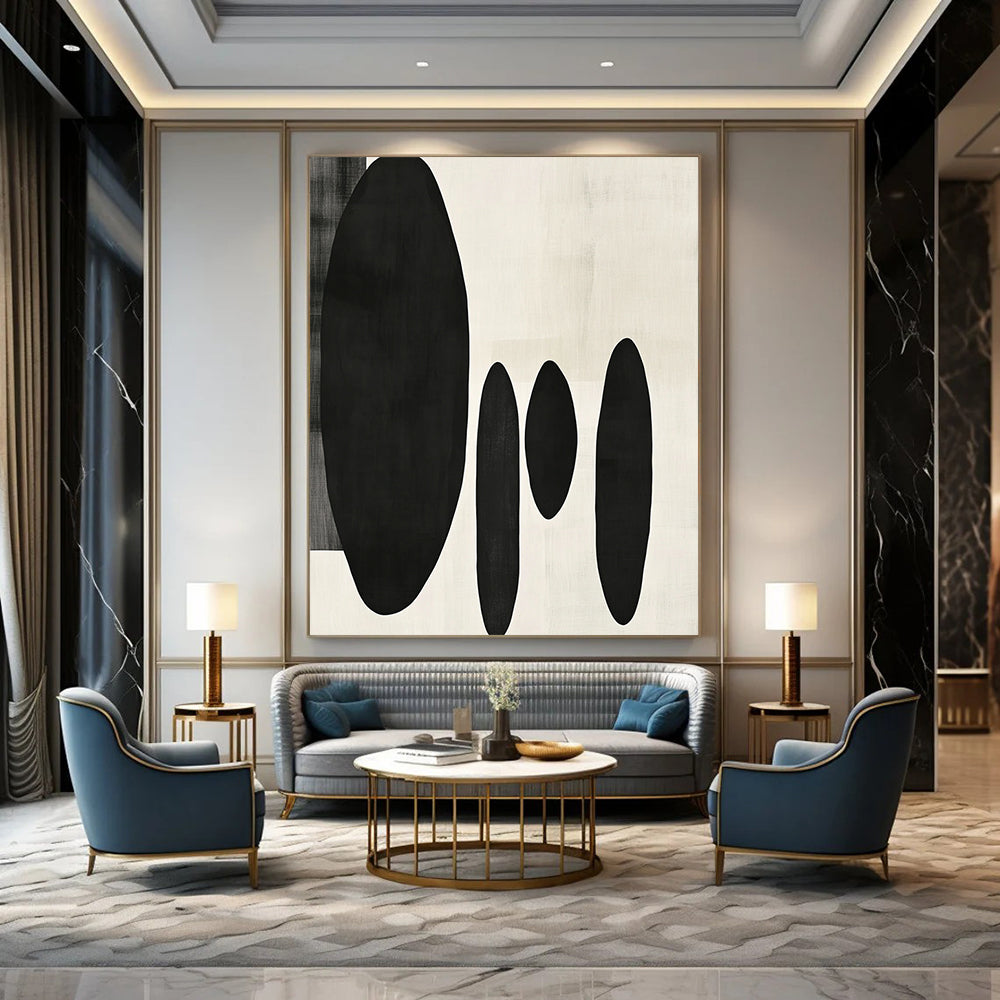 Contemporary minimalist artwork featuring organic black shapes balancing large forms on the left with delicate smaller shapes on the right. DLZ1547