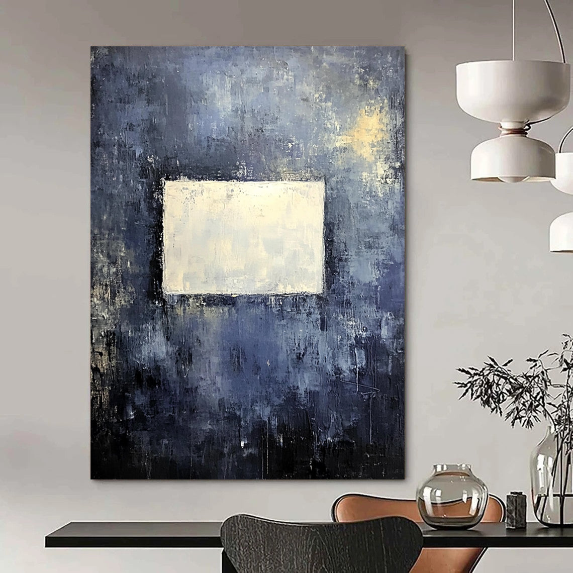 Bold contemporary abstract painting features a muted gray wall with dark blue and yellow tones highlighted by a central white square, creating a striking visual impact. DLZ0453