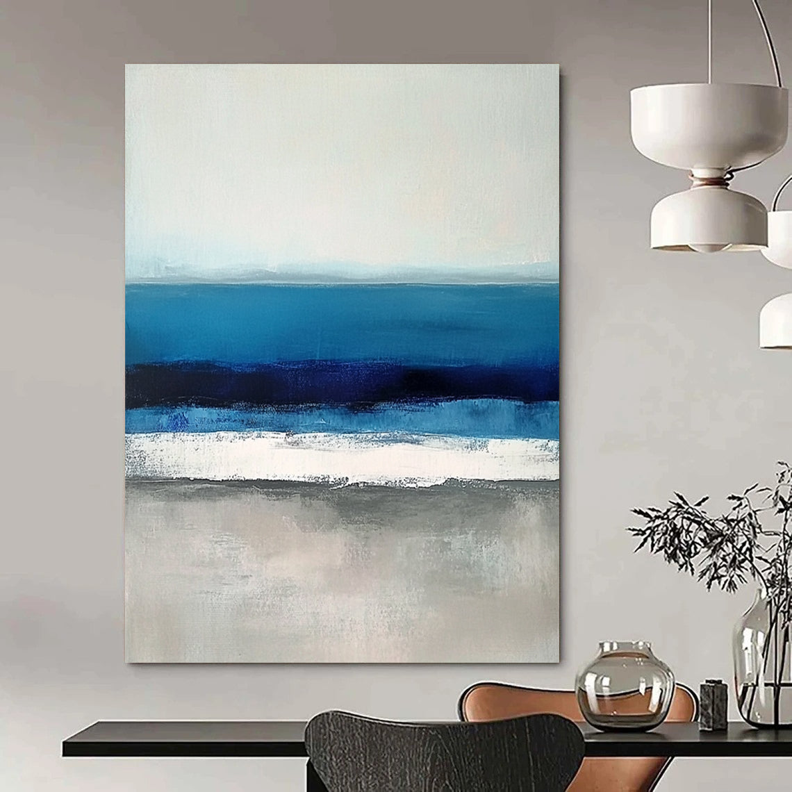 Large contemporary abstract painting featuring soft blues and grays capturing serene sea waves with a hint of deep blue for added depth. DLZ1359