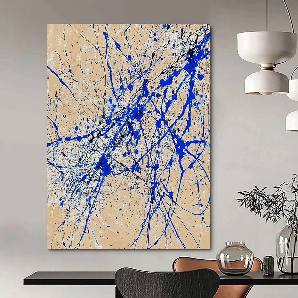 Contemporary abstract art features dynamic blue and white lines on beige paper in a vertical splatter style reminiscent of Jackson Pollock. DLZ0977