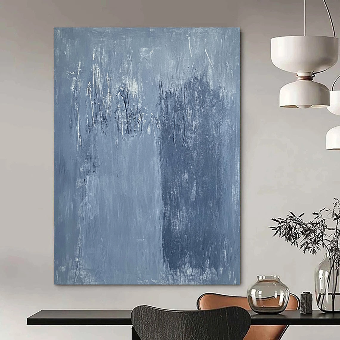 Large contemporary abstract painting in soft blue hues with textured surface and faint tree silhouettes against a deep gray background evoking calmness and emotion. DLZ1279