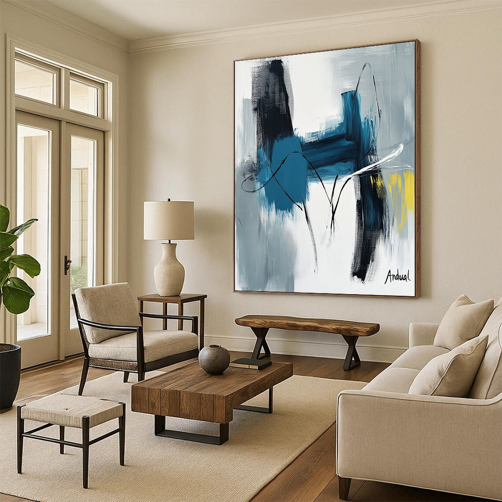 Contemporary abstract art showcasing "Andual" with bold strokes in blue and white on neutral canvas featuring black lines and hints of yellow or gray. DLZ0866