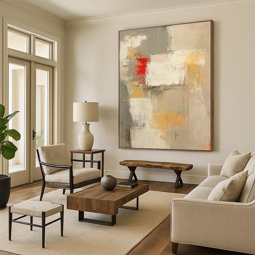Contemporary abstract painting features neutral tones with red and yellow accents large brush strokes and textures in expansive white spaces. DLZ0921