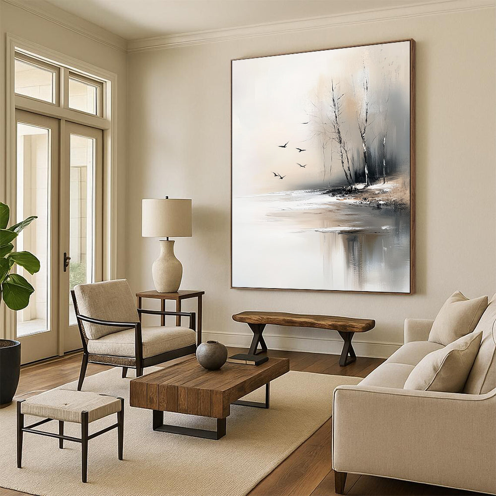 Large contemporary abstract painting featuring serene trees by an ice-covered lake with flying birds in soft gray and beige tones. DLZ0411