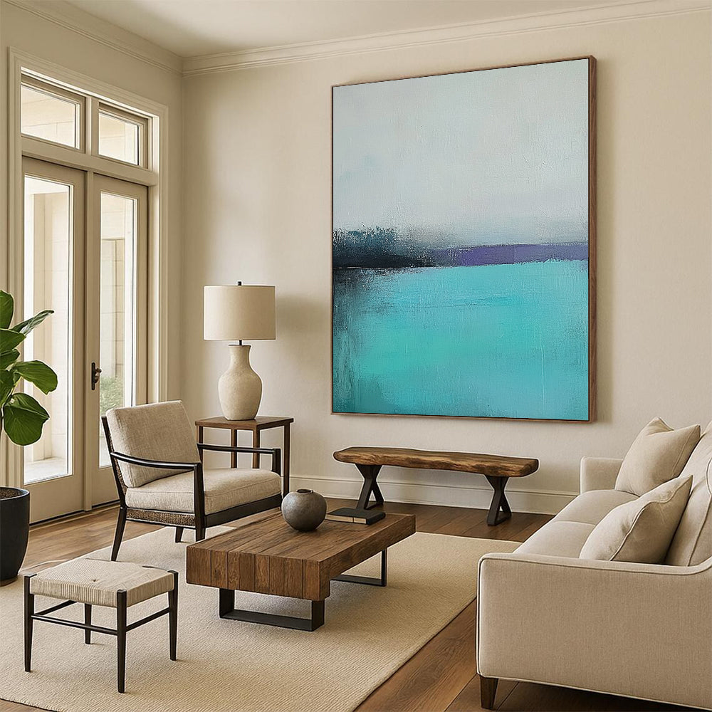 Large contemporary hand-painted abstract artwork captures a tranquil turquoise sea with a misty gray sky using muted colors and soft brush strokes for emotional depth. DLZ0428