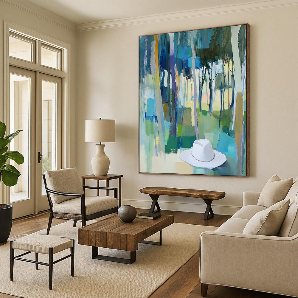 Contemporary abstract painting featuring trees in vibrant blue, green, and yellow hues with a white hat resting on the ground. DLZ0897