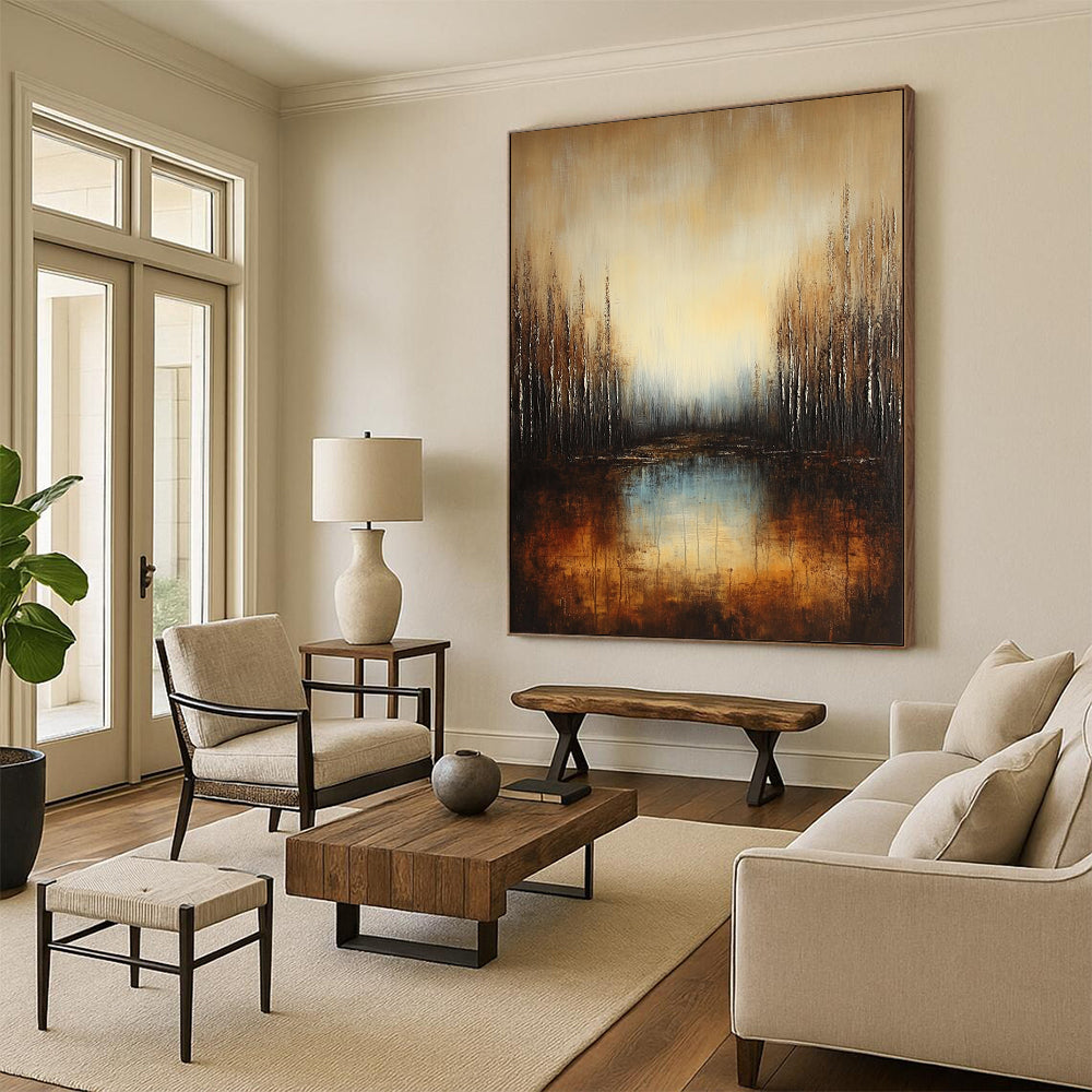 Large contemporary abstract painting featuring a deep brown and grey gradient with earthy orange hues and reflective water surrounded by soft blue trees. DLZ1294
