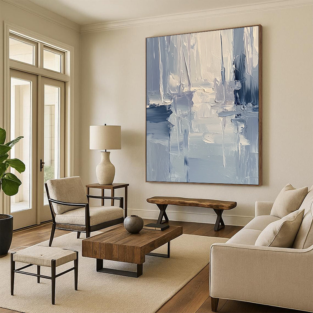 Large contemporary abstract painting featuring textured layers of blue and gray tones with soft lighting reflecting a serene coastal landscape. DLZ0352