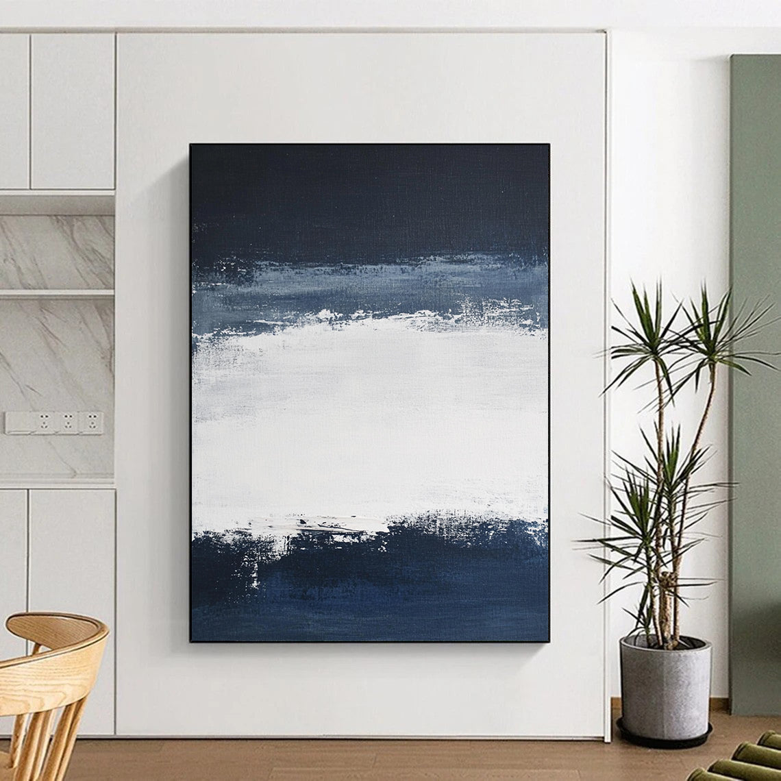 Large contemporary abstract painting featuring broad brush strokes in white and navy blue creating a tranquil atmosphere with a serene dark sky and soft gray clouds. DLZ0546