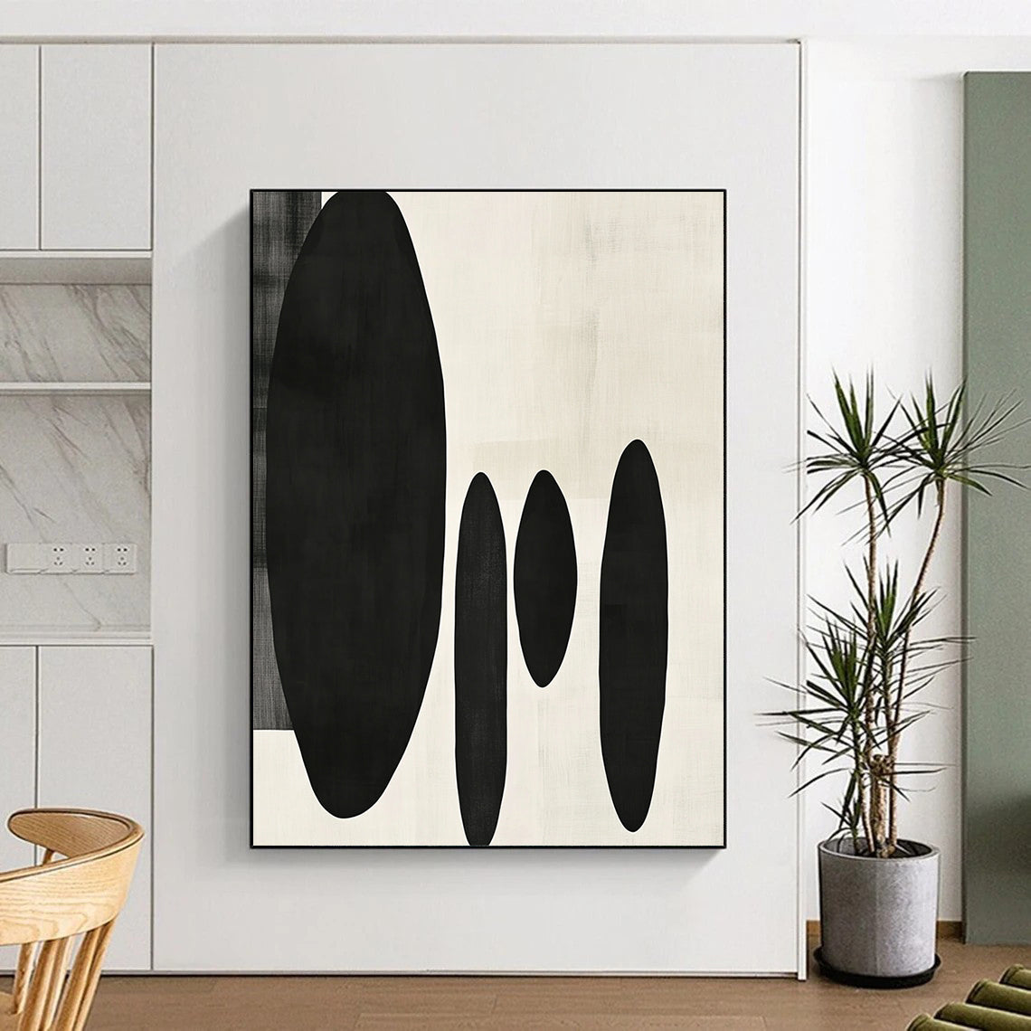 Contemporary minimalist artwork featuring organic black shapes balancing large forms on the left with delicate smaller shapes on the right. DLZ1547