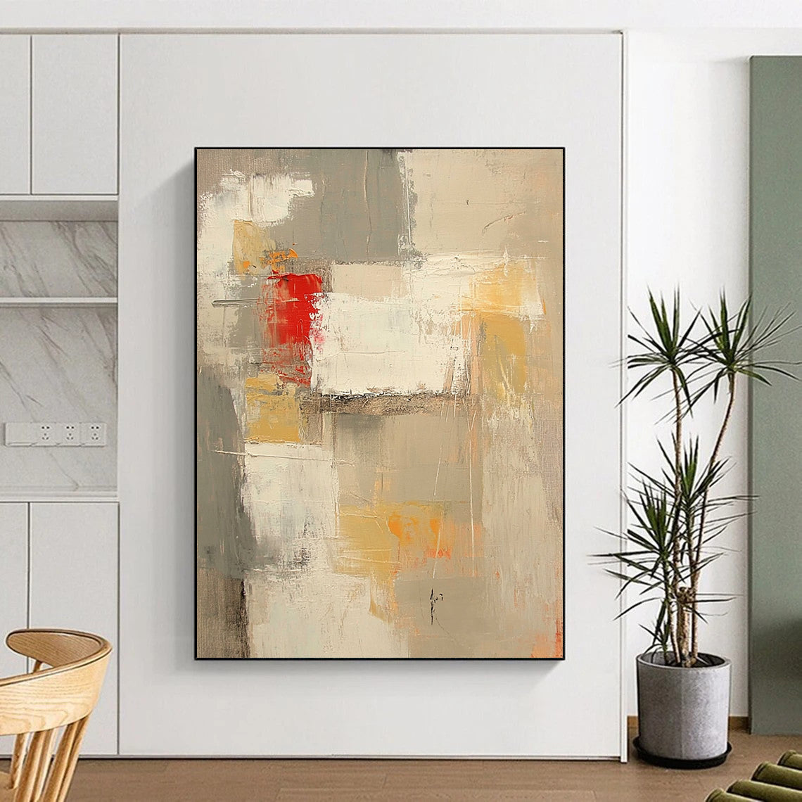 Contemporary abstract painting features neutral tones with red and yellow accents large brush strokes and textures in expansive white spaces. DLZ0921