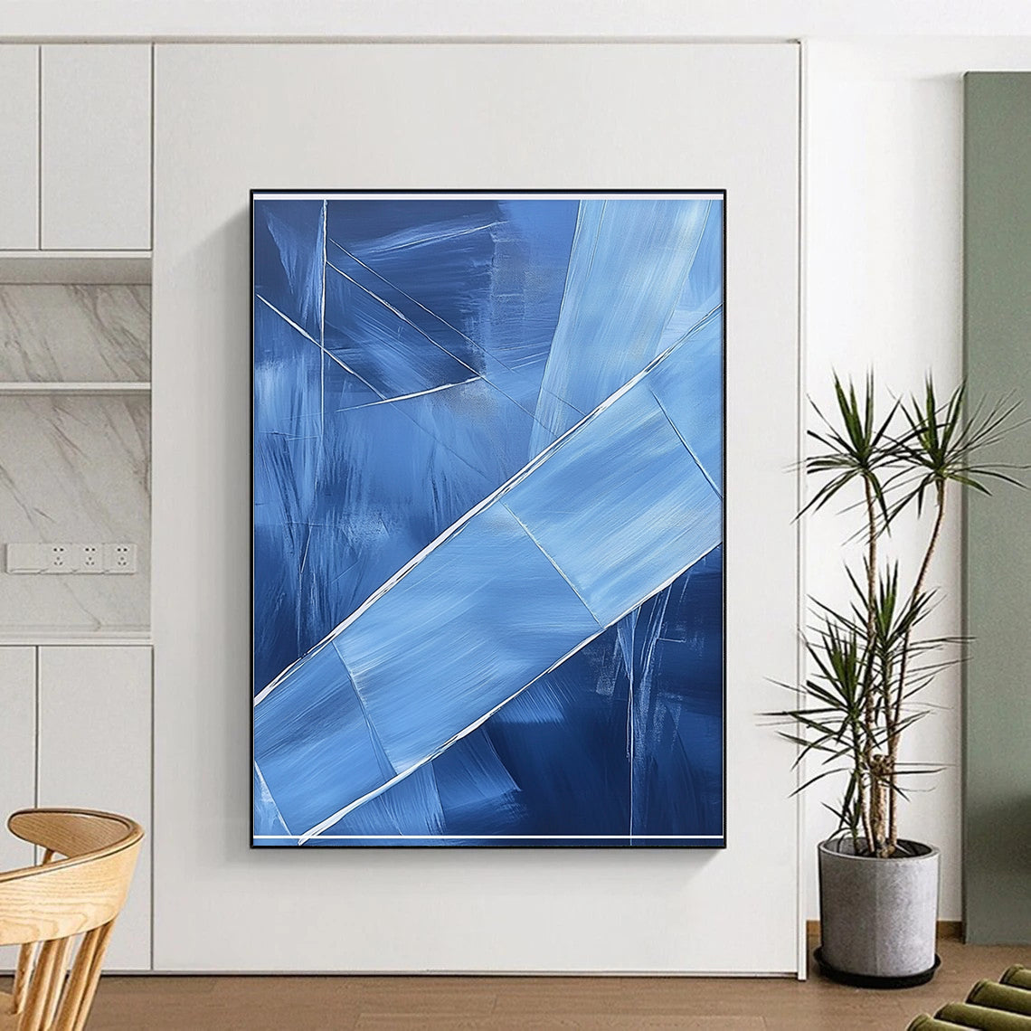 Contemporary hand-painted abstract art featuring blue shapes overlapping with soft edges and textured brushstrokes accented by a large white frame on the canvas. DLZ0367
