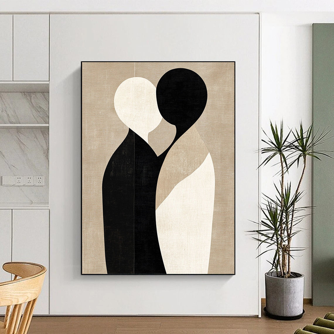 Large contemporary abstract art featuring minimalist shapes in black and beige, embracing forms on a textured light brown background. DLZ1464