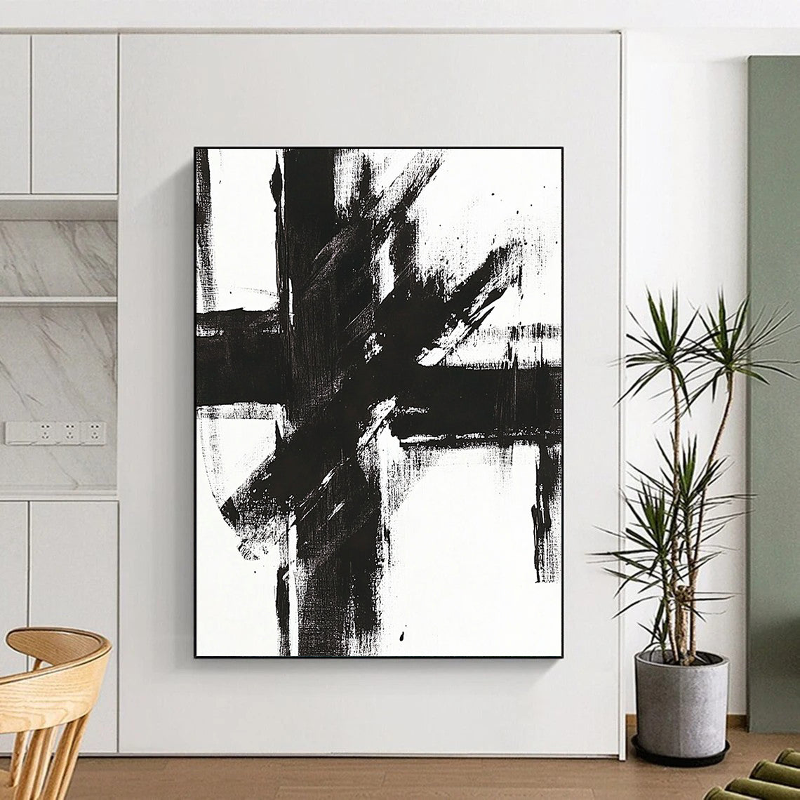 Contemporary abstract painting features a bold black and white cross with striking brush strokes on a bright canvas. DLZ0271
