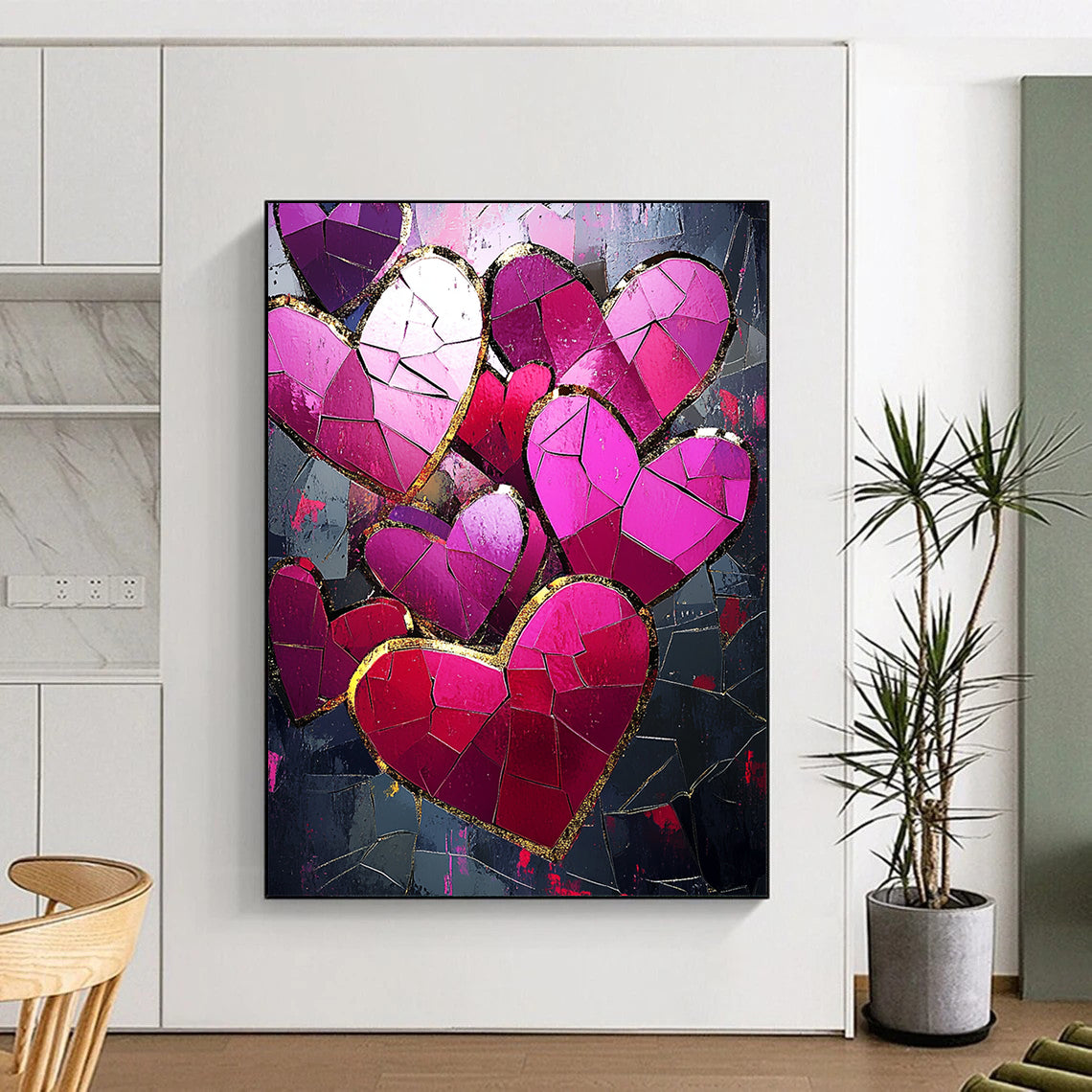 Contemporary abstract artwork features vibrant pink and red hearts with gold foil accents against a dark background illuminated by a mosaic of broken glass pieces. DLZ1721