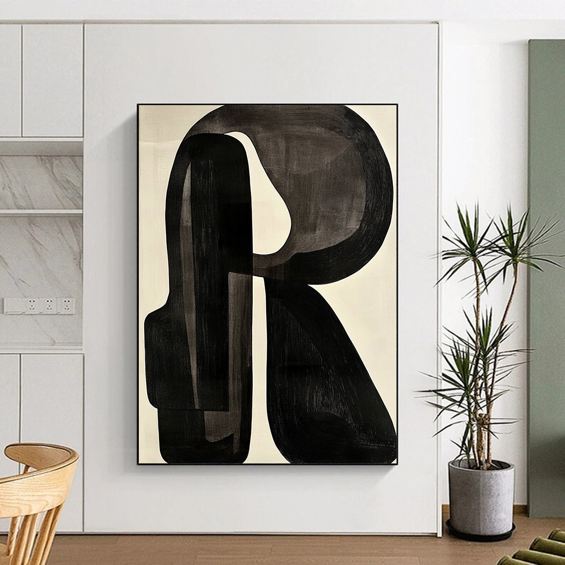 Contemporary abstract artwork featuring black and white shapes with a prominent letter R on a light gray background in the style of Jean Arp. DLZ0638